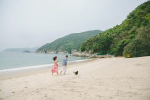 Newlyweds with their dog on beach