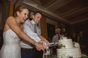 Wedding couple cutting the cake