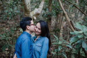 Husband kissing his wife on the cheecks