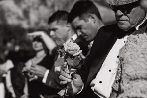Groom's father holding a rose