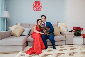 Lovely couple with dog sitting on couch