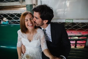Husband kissing the wife on cheecks