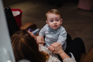 Adorable kid in his mom's lap