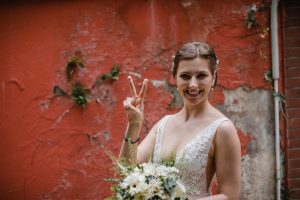 Beautiful bride posing with a victory sign