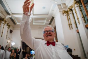 The groom's father raising a toast