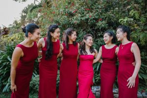 Bride and her bridesmaids dressed in red